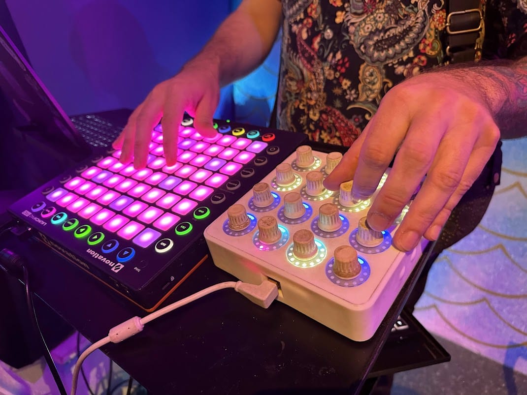 Hands on a Launchpad and a knob controller during a roboBOREALIS set, 2023